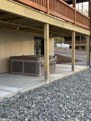 A covered outdoor area with a concrete floor and a wooden deck. - New Mountain Cabin, dark skies, and great views! (West Branch Township)