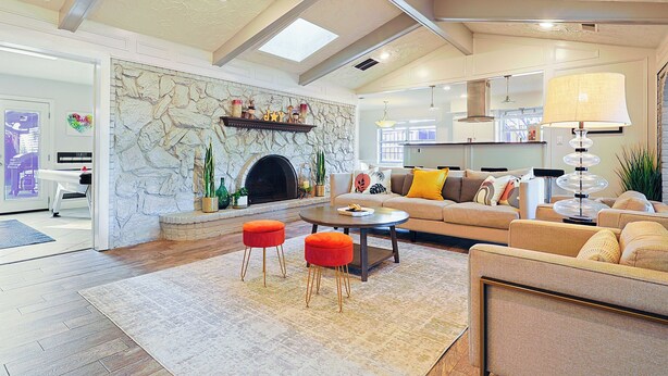 A spacious living room with a fireplace, a sofa set, and a dining area. - Resort Style 4BR Plano Retreat - Pool, Spa & Entertainment (Plano)
