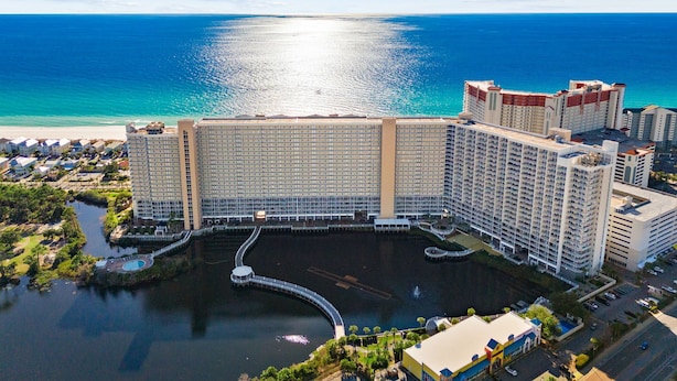 A large hotel with multiple high-rise buildings, a marina, and a beach. - Dolphin Views! Laketown Wharf - 7th Floor! (Panama City Beach)