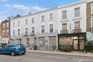 A two-story building with a ground-floor shop and upper residential units. - Royal College St NW1, Camden Town, Camden Rd (London)
