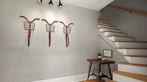 A staircase with wooden steps and a wall-mounted light fixture. - Delightful Appalachian Trail 2-bedroom lodge with AC in Central Damascus (Damascus)