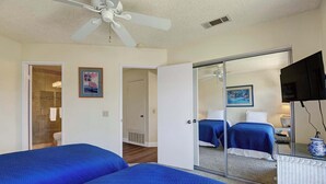 A hotel room with two beds, a ceiling fan, a shower, and a television. - Exclusive 2BR, Golf Views & Private BBQ (Palm Desert)