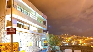 A two-story building with a sign reading "JORDAN GUEST HOUSE." - Jordan Guest House (Wadi Musa)