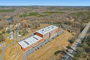 An industrial building with a flat roof and parking lot.