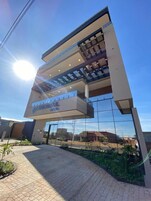 A modern building with a glass facade and a sign reading "MERCURIAL HOTEL".