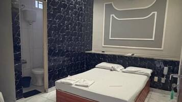 Basic Suite, Air conditioning, Garden View | Bathroom | Shower, towels, soap, toilet paper