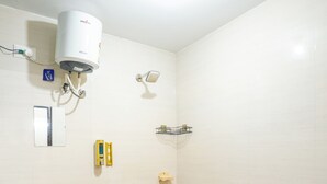 A bathroom with a sink, toilet, and shower.