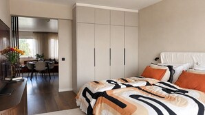 A bedroom with a bed, bedside table, and a wardrobe. - Borg Katariinankulma | Design Apt · Balcony With View · Free Parking (Pori)
