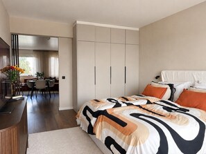 A bedroom with a bed, bedside table, and a wardrobe.
