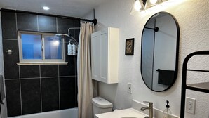 Un baño moderno con bañera, inodoro y lavamanos.