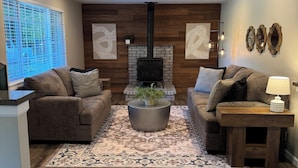 A living room with a fireplace, two sofas, a coffee table, and a rug. - Peaceful-Cozy Home!
Modern Touches & Outdoor
Space! (Buckley)