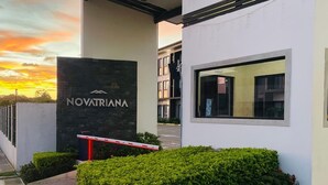 A modern building with a sign reading "NOVATRANA" and a gated entrance.