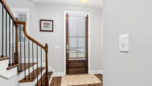 A staircase with wooden railings and a wooden door with blinds. - NEW Auburn townhome perfect for families! 3/3.5 (Auburn)