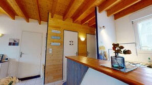 A kitchen with wooden beams, a wooden countertop, a stove, and a window. - Escapade Turballaise - House 400m from the Port (La Turballe)