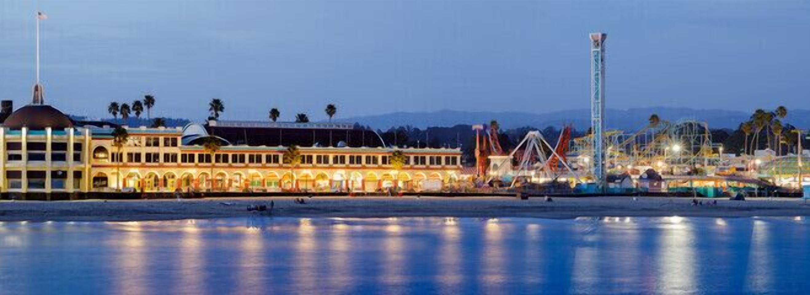 A waterfront hotel with a large building featuring arched windows and a prominent dome.