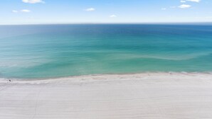 A beach with clear turquoise water and a wide sandy shore. - Princess Condos - All Units Are Gulf Front & Direct Beach Access in PCB! (Panama City Beach)