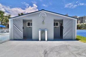 A single-story building with a gabled roof, two doors, and a small window. - B 11 Sundown Condominiums (Pensacola)