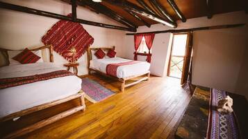 A traditional room with two wooden beds, a bench, and a small table.
