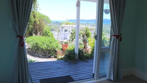 A room with a view of a garden and a white gazebo. - Cherry Villa (Paraparaumu)