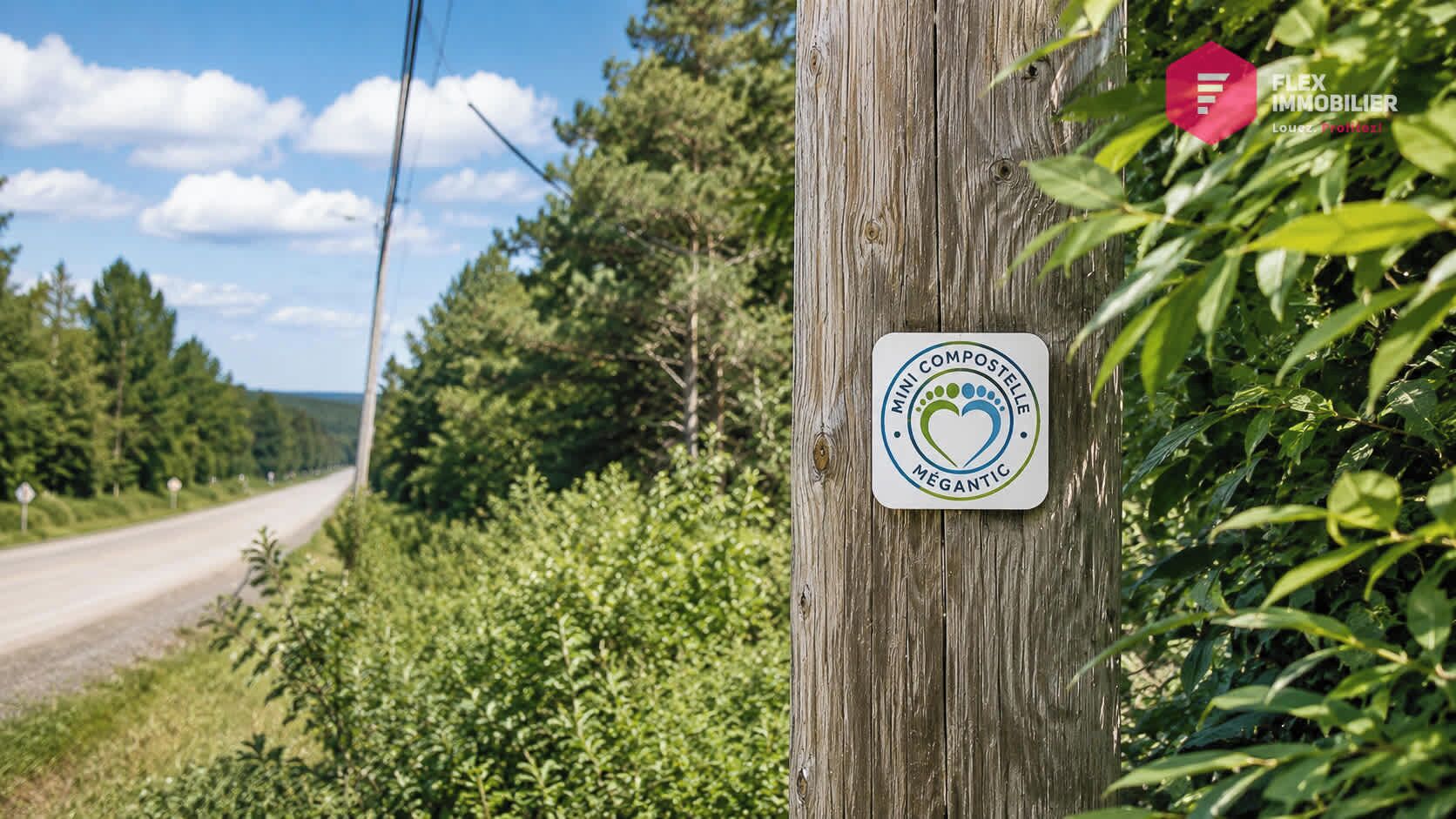 A wooden utility pole with a sign that reads 'COMPOS Mini Coastelle Mégantic.'
