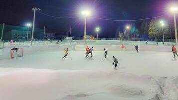 An outdoor ice skating rink at night with artificial lighting.