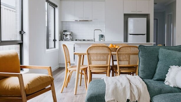 A modern living room with a sofa, chairs, and a dining table. - 2 Houses, Sleeps 12, 4 Bathrooms, Private Location (Sale)