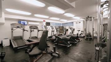 A gym with treadmills, elliptical machines, and weightlifting equipment.