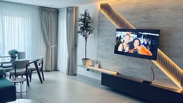 Family Apartment, Balcony, City View | Living area | Flat-screen TV