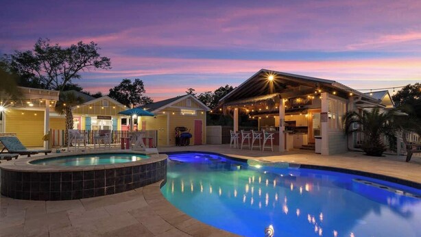 A swimming pool with a hot tub, outdoor seating, and a covered area with string lights. - Suite "Flamingo Pointe" with Shared POOL! (Bay St. Louis)