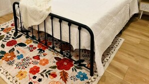 A bedroom with a bed, a window with curtains, a bedside table, a nightstand, and a painting on the wall. - Casa De Campo Unit B Up to 3 (Tampa)