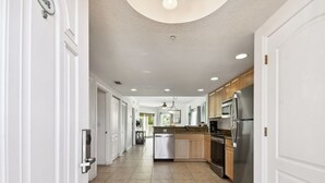A modern kitchen with stainless steel appliances, a dishwasher, and wooden cabinets. - Sunsets & Coastal Vibes | Treasure Island Stay (Treasure Island)