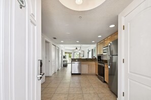 A modern kitchen with stainless steel appliances, a dishwasher, and wooden cabinets. - Sunsets & Coastal Vibes | Treasure Island Stay (Treasure Island)