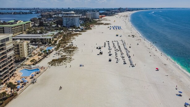 An aerial view of a beach with a hotel and pool area. - Sunsets & Coastal Vibes | Treasure Island Stay (Treasure Island)