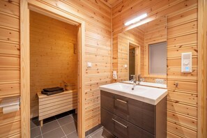 A wooden cabin bathroom with a large sink, a mirror, and a towel rack. - Furuhus 8p - Four Bedroom Chalet, Sleeps 8 (Vrådal)
