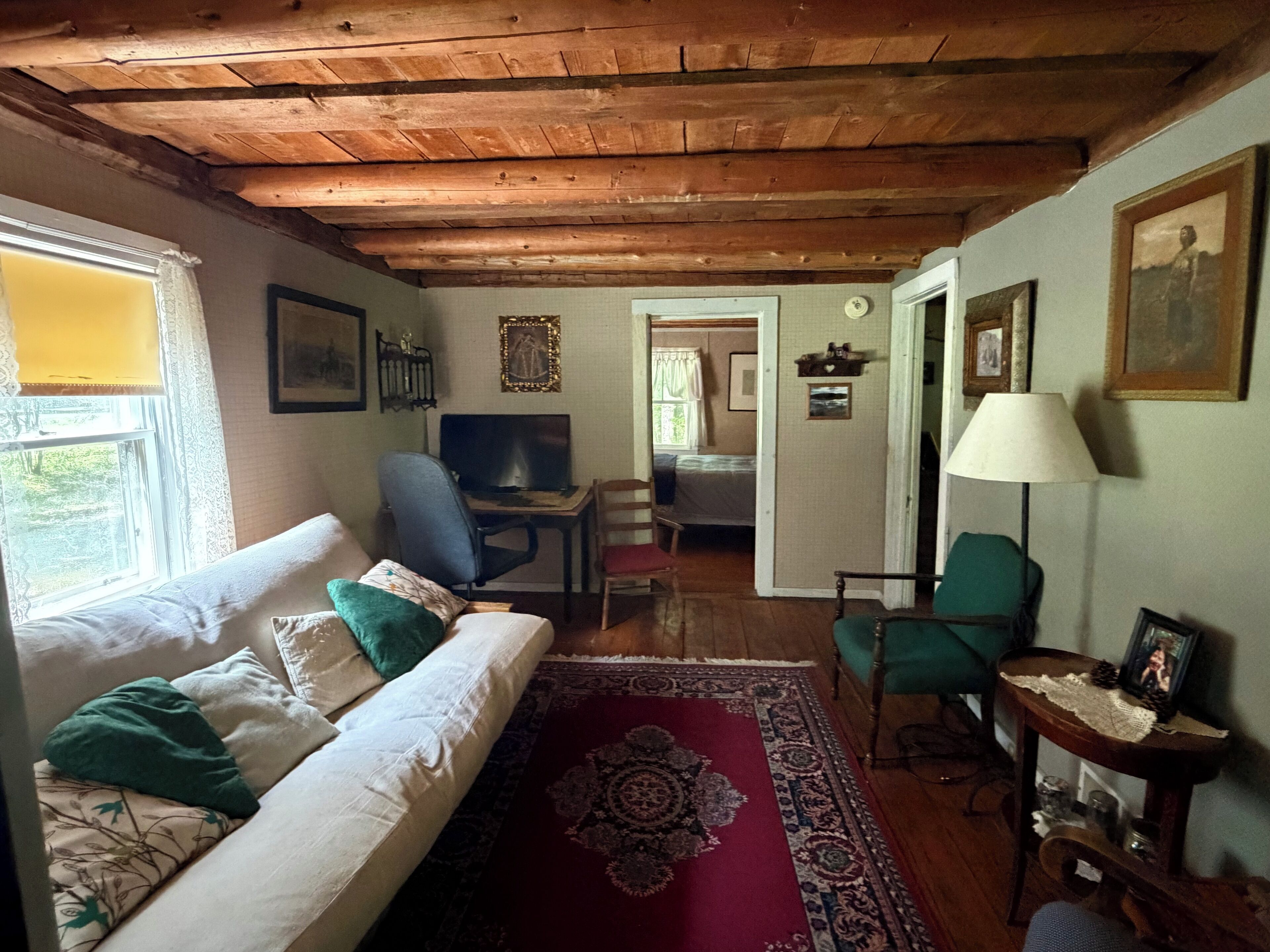 Een gezellige kamer met een bed, bureau, stoel en lamp.