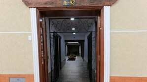 A hotel entrance with a number sign above the door, a tiled floor, and a brick wall. - HOTEL COLONIAL A 100 MTS DE LA BASILICA (Guadalajara de Buga)