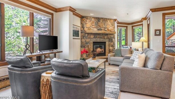 A spacious living room with a stone fireplace, leather sofas, and a flat-screen TV. - DON'T MISS THIS TRUE SKI IN/SKI OUT VILLAGE GEM, PRIME LOCATION, SLEEPS 5 (Beaver Creek)