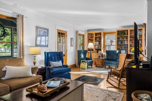 A living room with a sofa, armchairs, a coffee table, and a bookshelf. - Welcome to All-Seasons Downtown Beulah Beauty! (Beulah)