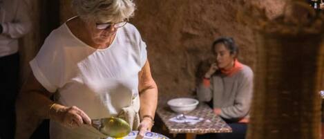 A person serving food at a table with dishes.
