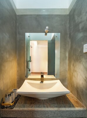 A bathroom with a large mirror, a sink, and a shower door. - Talpe Paradise (Galle)