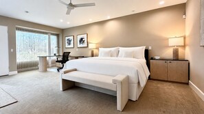A bedroom with a bed, bedside tables, a desk, and a chair. - Grande Vista Villa: 3 bed/3 bath Luxury Living; Stunning Lake & Mountain Views | a Greenday property (Rancho Mirage)