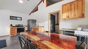A modern kitchen with a large wooden island, built-in appliances, and wooden cabinets. - Yurt 2 - The Gold Miner (Boise County)