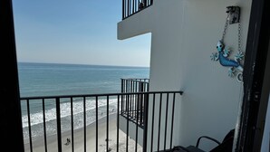A balcony with a view of the beach and ocean. - Beachfront condo w/ balcony in wonderful Garden City Beach (Murrells Inlet)