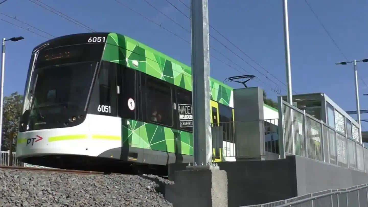 A modern tram with the number 6051, indicating it is part of a public transportation system.