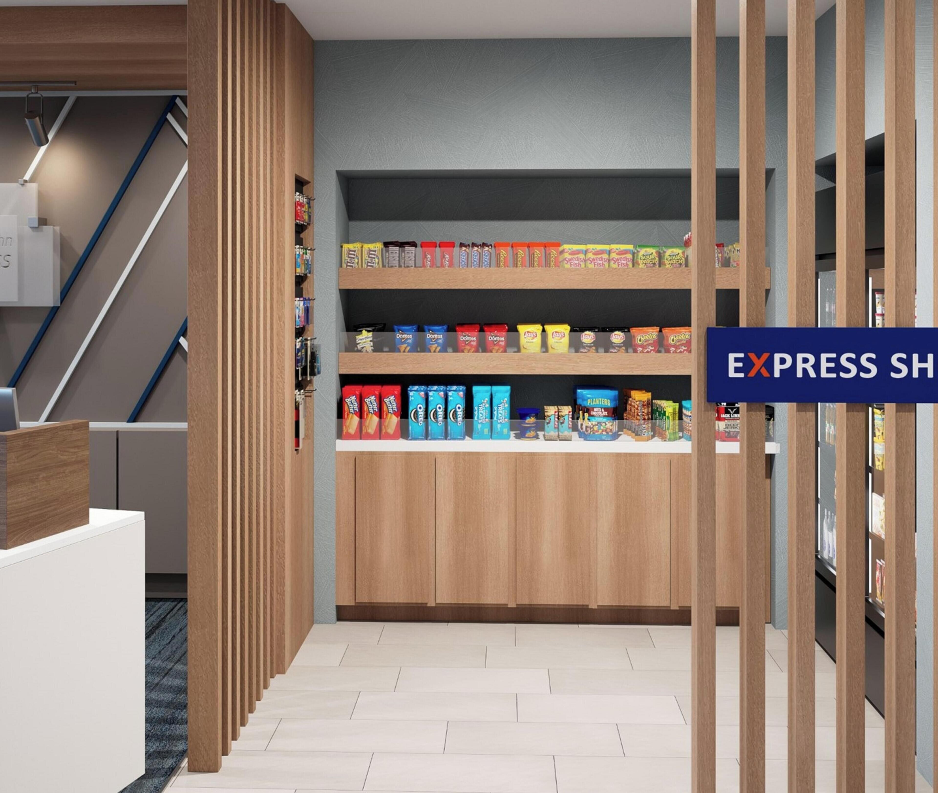 A modern retail space with wooden shelving stocked with snacks and a sign reading 'EXPRESS SHOP'.