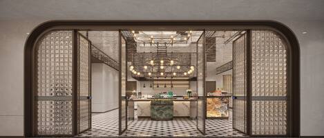 A modern interior with a central bar area, patterned floor, and decorative ceiling lights.