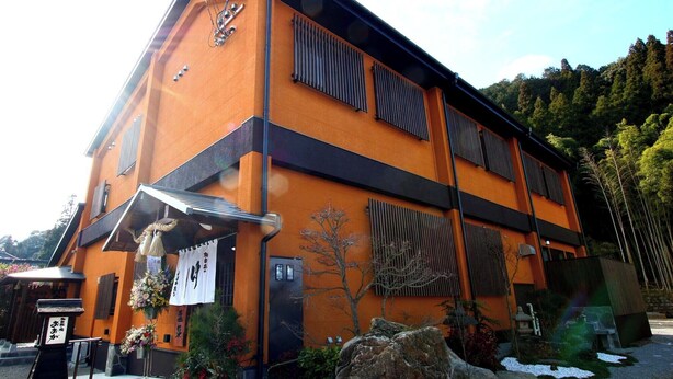 A building with a modern design, featuring a combination of orange and black colors. - Hitoyoshi Onsen Oga no Yado (Hitoyoshi)