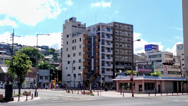 A multi-story building with a mix of commercial and residential spaces, including a visible storefront and balconies. - Sasebo Terminal Hotel (Sasebo)