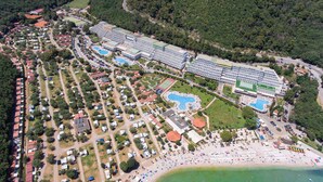 An aerial view of a resort with multiple swimming pools, a beach, and a large hotel complex. - Holiday Home with Pool and Wi-Fi (Rabac)