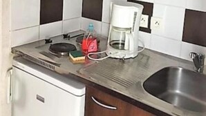 A compact kitchen with a microwave, coffee maker, and a small refrigerator. - Adagio Access Grenoble (Grenoble)